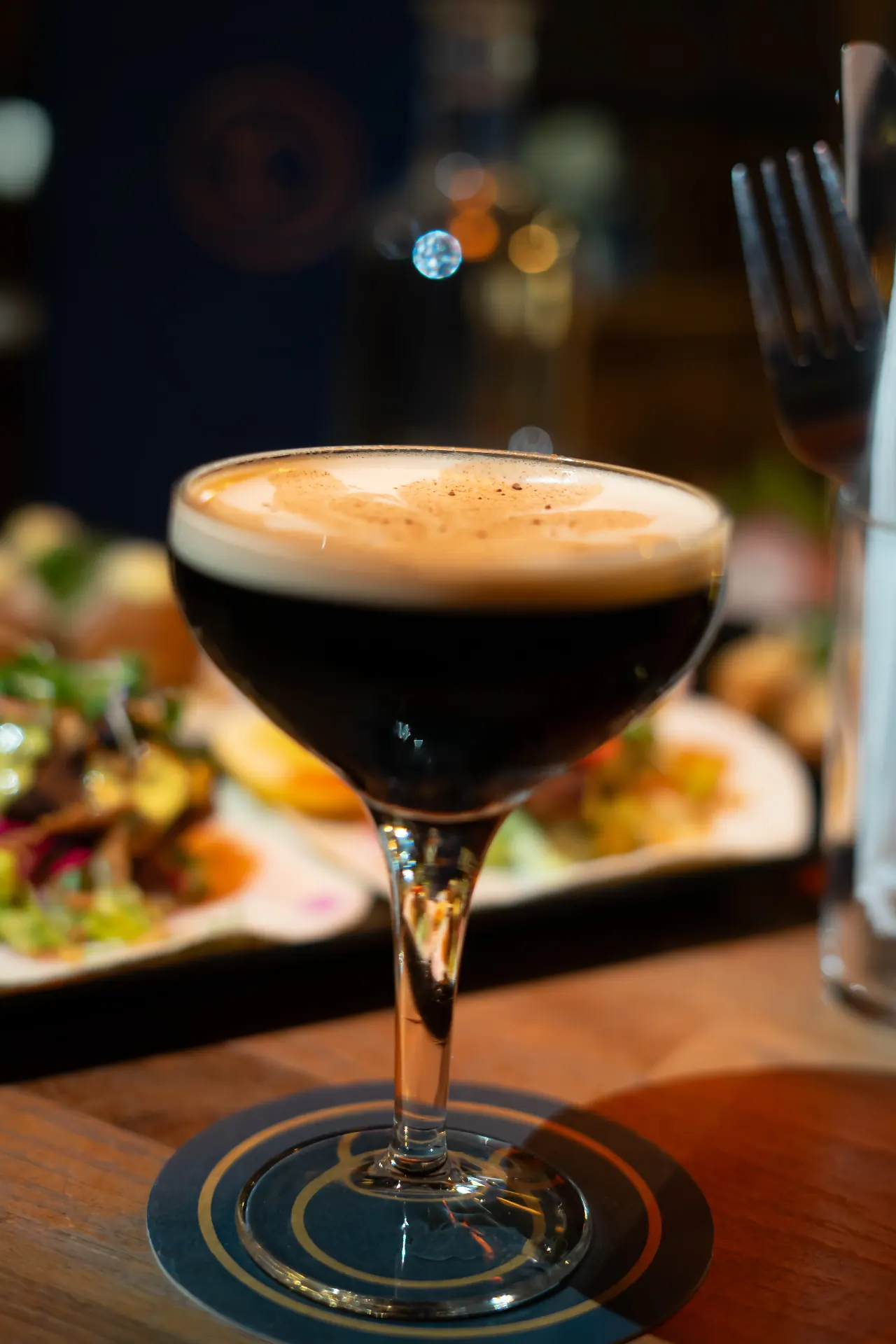 Espresso martini in a coupe glass with foam crema