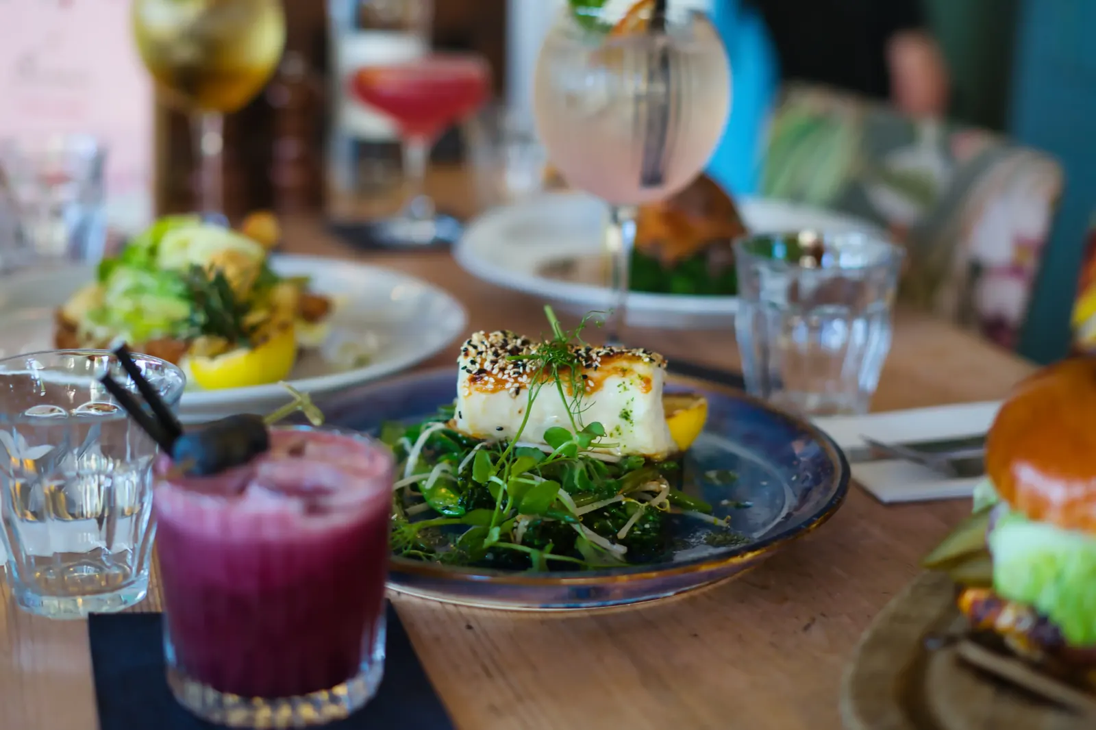 Sesame-crusted halibut on greens with cocktail